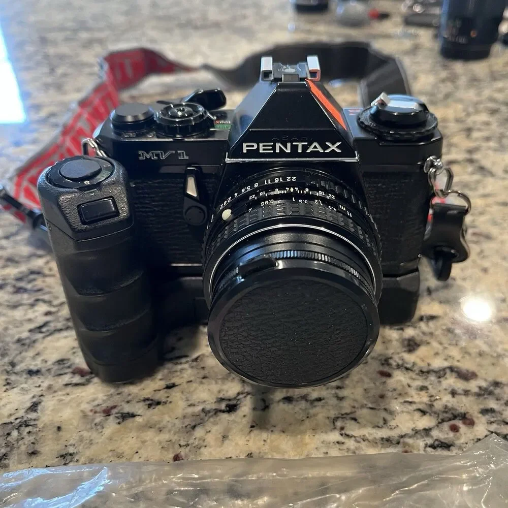 Asahi Pentax MV-1 35mm SLR Film Camera With lens, Mount, Strap and documents